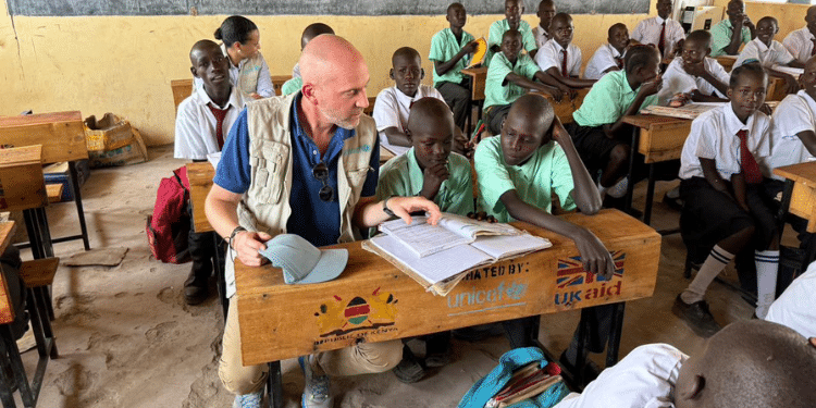 A UNICEF official with school children in Kenya. 