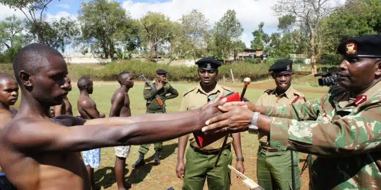 Police officer inspecting a man during recruitment. PHOTO|CTV