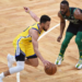 REUTERS | Stephen Curry controls the ball while Kemba Walker defends in Boston, on April 17, 2021