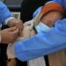 AFP | A Libyan medic administers the AstraZeneca vaccine to an elderly woman in Tripoli as authorities launch a national inoculation drive against coronavirus