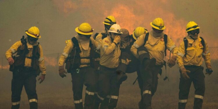 AFP | One firefighter collapsed from smoke inhalation