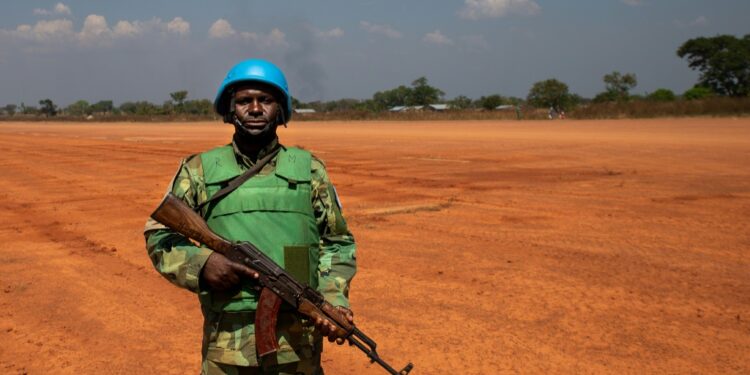 A United Nations (UN) peacekeeper waits for a helicopter to land in Paoua on December 2, 2021 | AFP