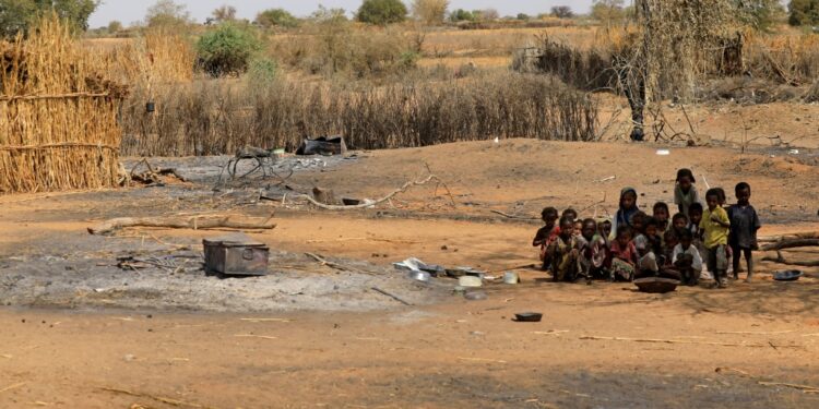 Sudanese children sit together on February 2, 2021 following violence in the Darfuri village of al-Taweel Saadun, 85 kilometres south of the South Darfur state capital Nyala | AFP
