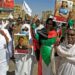 Demonstrators in Khartoum North hold pictures of protesters killed in earlier demonstrations, during a march calling for civilian rule | AFP