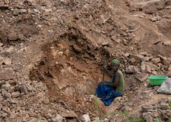 Artisanal miners hunt for cassiterite, a tin ore, at Manono | AFP