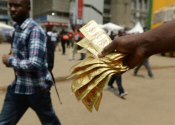 A healthcare worker distributes condoms in Kenya's capital Nairobi. Around 1.1 million condoms donated to the country have disappeared from a government warehouse | AFP