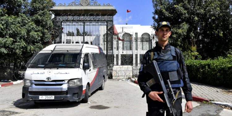 A Tunisian officer stands guard outside parliament in Tunis on March 31 | AFP