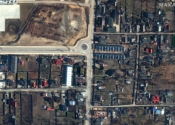 This handout satellite image released by Maxar Technologies shows a view of Yablonska Street in Bucha, Ukraine, on March 19, 2022, when bodies of civilians were on the street and found by Ukrainian officials weeks later when Russian forces withdrew | AFP