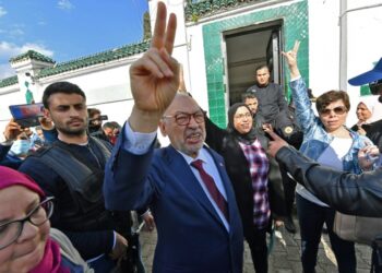 Tunisia's speaker of the dissolved parliament, Rached Ghannouchi, flashes the victory sign as he arrives for questioning at the judicial police headquarters in the capital Tunis | AFP