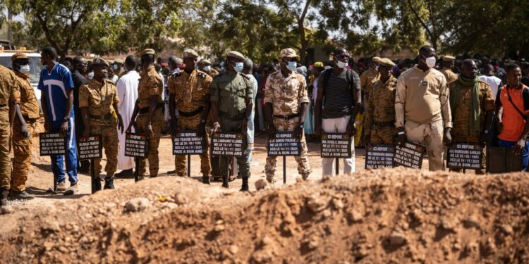 Jihadist toll: Military officials at Gounghin cemetery in Ouagadougou last November, bearing signs with the names of soldiers killed in an attack the week before | AFP