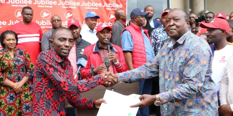 Nakuru Town West MP Samuel Arama receiving his nomination certificate from the jubilee party