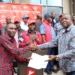 Nakuru Town West MP Samuel Arama receiving his nomination certificate from the jubilee party