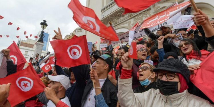 Tunisian demonstrators chant slogans and wave their country's national flag in support of President Kais Saied, in the capital Tunis | AFP