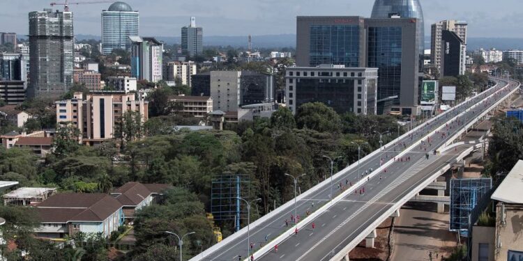 An aerial view of runners taking part in the inaugural Nairobi marathon as they run along the new expressway as an inaugural annual event in Nairobi on May 8, 2022. Kenyan President Uhuru Kenyatta announced after the marathon that the Expressway would be opened for use on a trial basis starting May 14, 2022. (Photo by Tony KARUMBA / AFP)