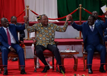 Uhuru Kenyatta (centre) holds hands with opinion polls’ favourites, Deputy President William Ruto (left) and former Prime Minister Raila Odinga | Tony Karumba/AFP via Getty Images