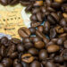 Geographical map of Kenya covered by a background of roasted coffee beans. This nation is one of the main producers and exporters of coffee. Horizontal closeup image.