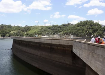 Officials inspect water levels on the Kariba Dam in Zimbabwe. 
Photograph: Philimon Bulawayo/Reuters]