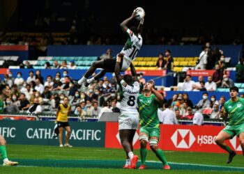 AFP Kenya's Johnstone Olindi (top) is lifted by teammate Herman Humwa (C) against Ireland in the Hong Kong Sevens rugby tournament on November 4, 2022. Kenya's Rugby Sevens