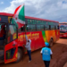 The Burundian flag flies at the head of a convoy of buses moving refugees back home from Tanzania in 2019 | Tchandrou Nitanga/AFP via Getty Images