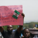 Parents and relatives of students from the Federal College of Forestry Mechanization in Kaduna, who were kidnapped, hold placards during a demonstration in Abuja on May 4, 2021. | Kola Sulaimon/AFP via Getty Images
