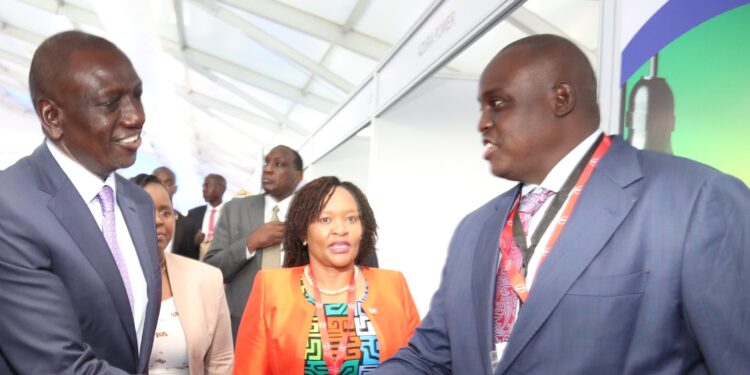 Preident William Ruto (left) and EPRA Director General Daniel Kiptoo shake hands at a past event.