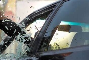Unknown person breaking car window . PHOTO/Courtesy