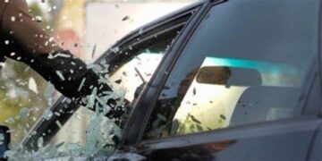 Unknown person breaking car window . PHOTO/Courtesy