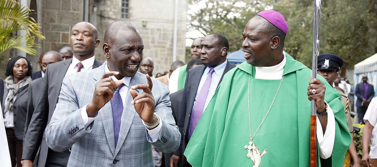 Pres Ruto gestures as he chats with ACK's Bishop Ole Sapit