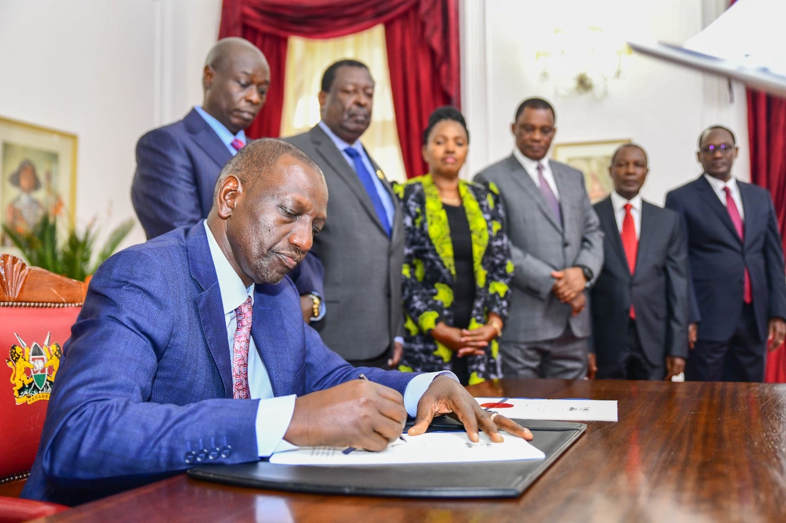 President William Ruto signs the Finance Bill 2023 into law on June 26, 2023. Looking on are Deputy President Rigathi Gachagua, Prime Cabinet Secretary Musalia Mudavadi and other leaders. 