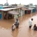Villagers go about their business in a flooded market center in Kisumu, about 400 kilometers west of the capital Nairobi in Kenya. PHOTO/Courtesy