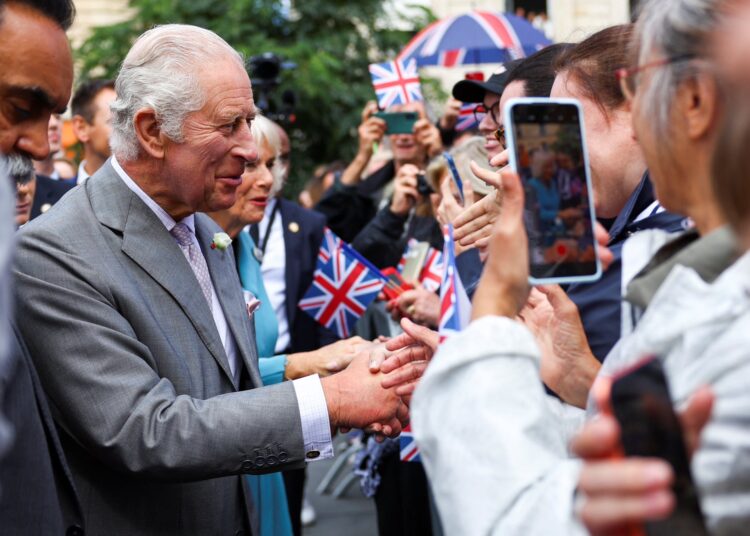 UK's King Charles interacts with members of the public at past function. 