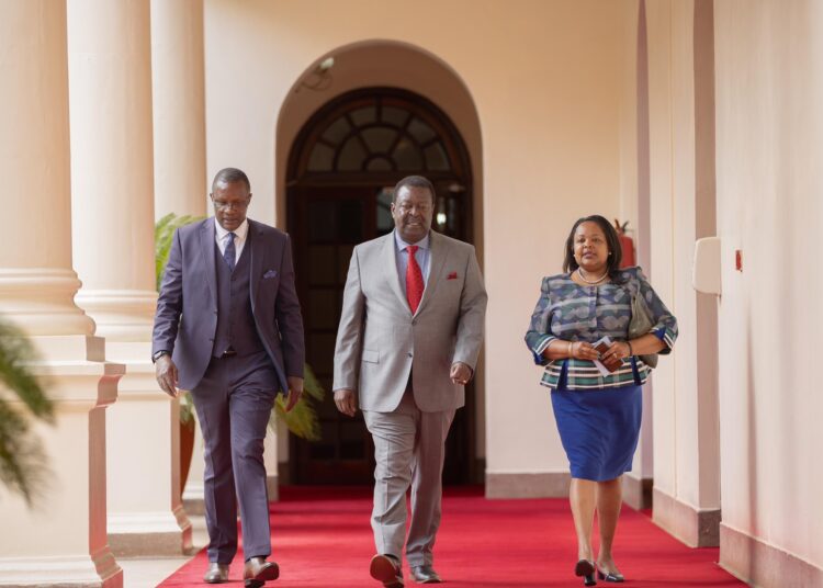 Prime CS Musalia Mudavadi (center), ICT CS Eliud Owalo, and Secretary to the Cabinet Mercy Wanjau take a stroll at State House. 