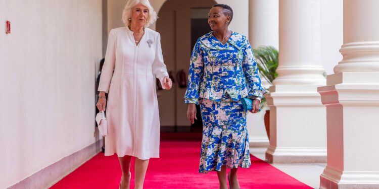 The queen, known for her iconic sense of fashion arrived at State House Nairobi alongside her husband King Charles III in a white crepe silk dress with stunning stitching details down the middle and an open V neck at the top. 