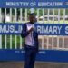 Famous political enthuathiast Nuru Okanga poses for a photo outside the Mumias Muslim Primary School in Kakamega.