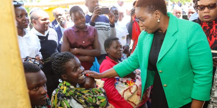 Health CS Susan Nakhumicha (right) interacts with mothers. 