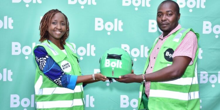 Bolt Country Manager in Kenya Linda Ndungu (left) presents a helmet to a bolt boda boda rider in the past. 
