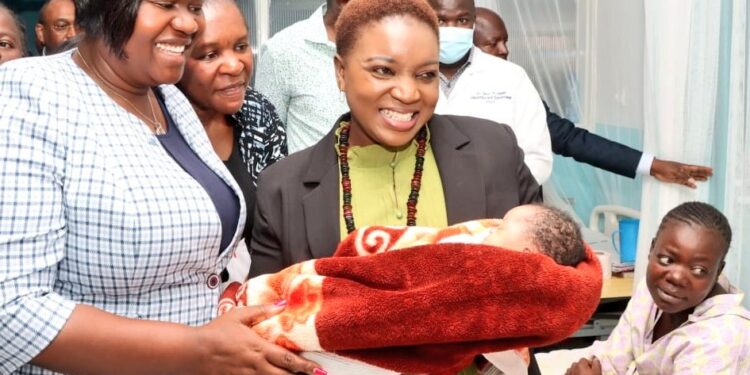 Health Cabinet Secretary Susan Nakhumicha (right) and Homa Bay Governor Gladys Wanga hold a baby during a past function in Homa Bay. 