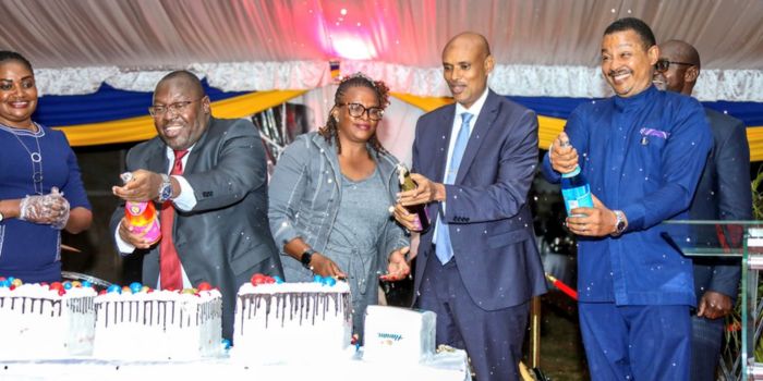 DCI Boss Mohamed Amin (second from right) leads other guests in popping drinks during the DCI end year celebrations. 