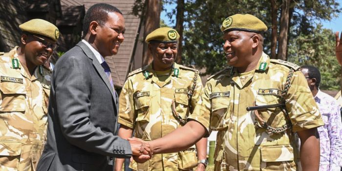 Tourism CS Aflred Mutua (left) interacts with KWS officers on December 8, 2023. 