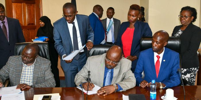 Cooperatives Cabinet Secretary Simon Chelugui (left) and SASRA Board signs the perfomance contract with SASRA officials.