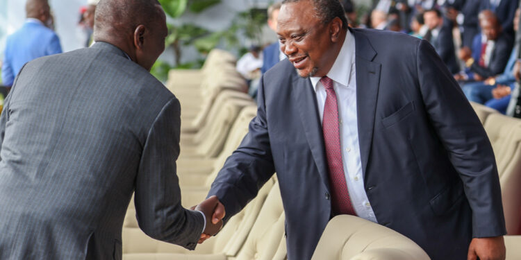 President William Ruto shakes hands with his predecessor Uhuru Kenyatta during the swearing in of DRC President Félix Antoine Tshisekedi Tshilombo.