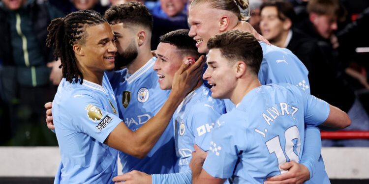 Manchester City players celebrating a Hatrick from Phil Foden.