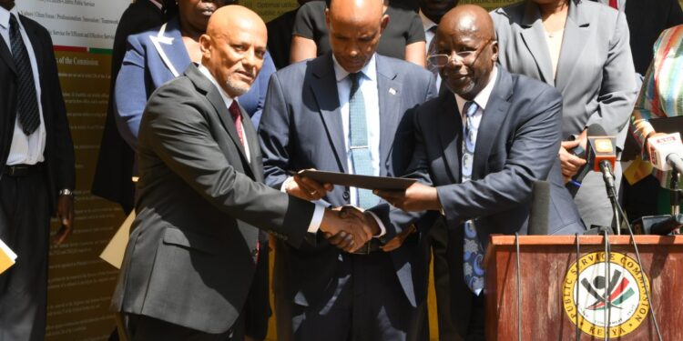 Public Service Commission Chair Ambassador Anthony Muchiri handing over forgery report to EACC CEO Twalib Mbarak. PHOTO/ Courtesy