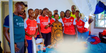 Arsenal supporters visit a mother who gave birth to triplets to donate items at Kakuma Mission Hospital in Turkana West.