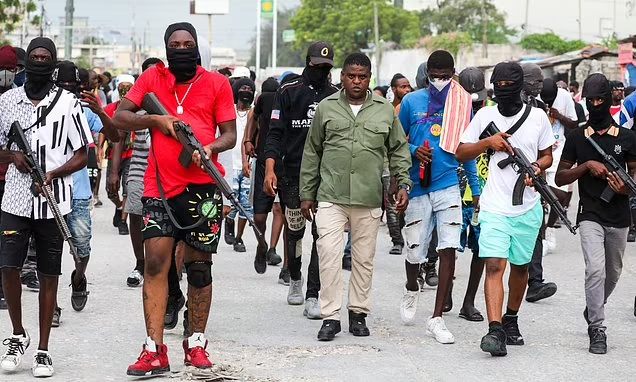 Gang leader Jimmy Cherizier with his team walking in streets of the Haiti capital of Port-au-Prince. PHOTO/Courtesy.