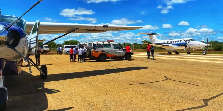 Paramedics from the Kenya Redcross and AMREF prepare to airlift survivors of the KU bus crash to Nairobi for treatment on Tuesday, March 19.