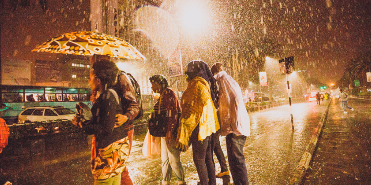 A photo of Kenyans walking in the streets during a rainy night in Kenya. PHOTO/Courtesy.