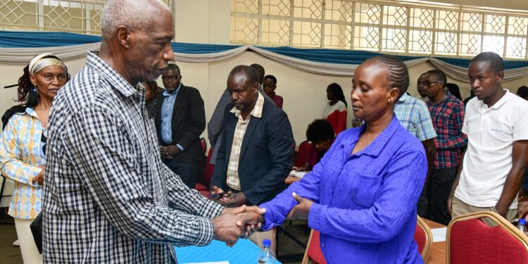 Kenyatta University Vice Chancellor Paul Wainaina interacting with a parent. PHOTO/ Kenyatta University.