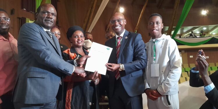 Former IEBC Chairman Wafula Chebukati hands presidential aspirant clearance certificate to Walter Nyambane. PHOTO/NMG.Redykyulass comedy group