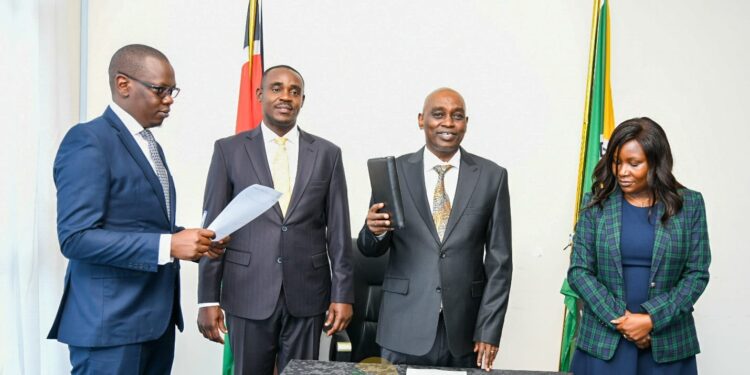 KRA Board Chairman Anthony Mwaura (center) takes his oath as UDA NEB Chairperson at the party's Milimani Headquarters. Looking on are Embu Governor Cecily Mbarire (right) and UDA Secretary General Cleophas Malala. 